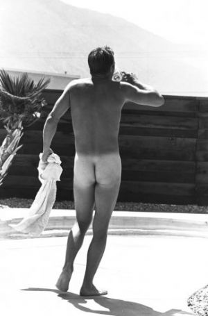 In 1963, McQueen strolls around his Hollywood backyard in the buff